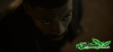 John Stewart, in a leather jacket, looks up into the night sky, then lifts off the ground and flies away over the trees and lights of Rushville in the Lanterns season finale